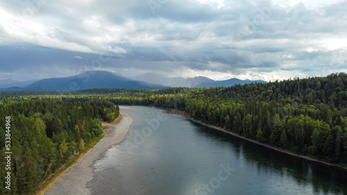 Wild nature landscape drone view with river and forest. Fog above water. Mountain Siberian river flow, water on stones, forest trees. aero view.