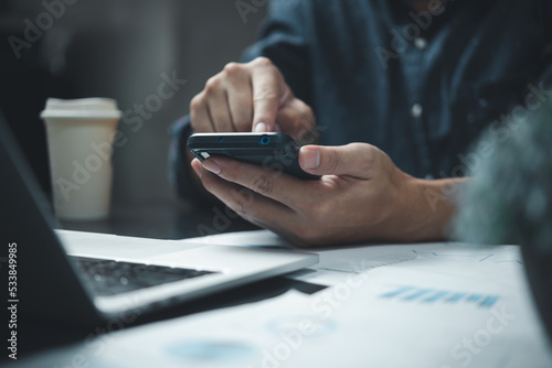 Businessman using smartphone marketing laptop computer business network manager. man using notebook internet online technology communication.