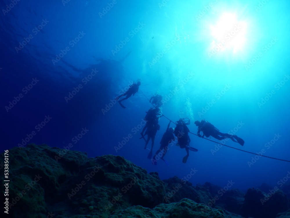 scuba divers around the boat for diving underwater scenery ocean scuba divers around the boat for diving underwater scenery ocean