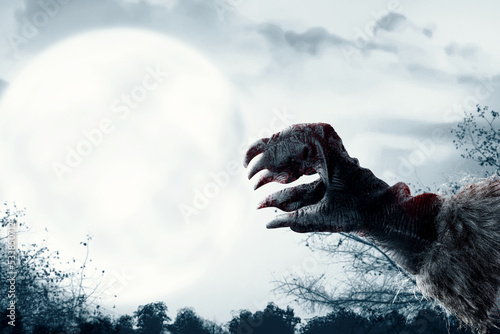 Werewolf hand with a full moon