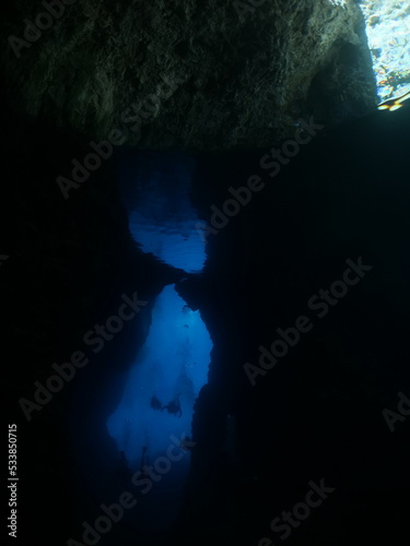 exploring and enjoying the caves underwater cave dive blue background