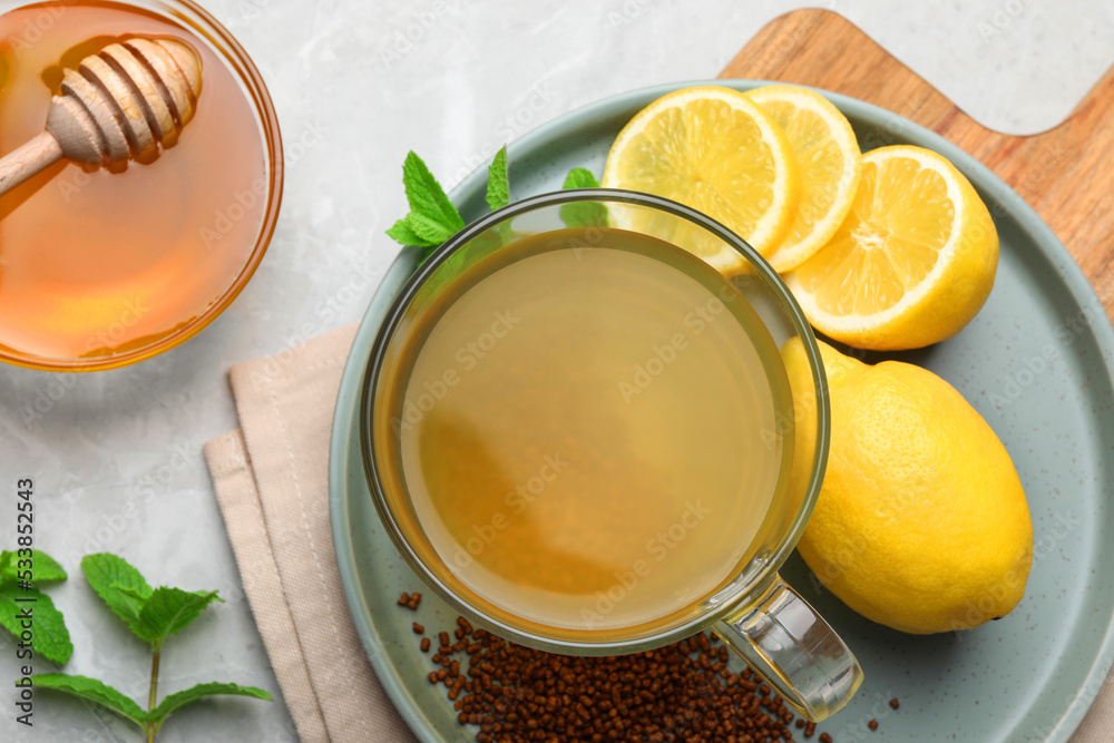 Buckwheat tea, lemon and honey on light grey marble table, flat lay Buckwheat tea, lemon and honey on light grey marble table, flat lay