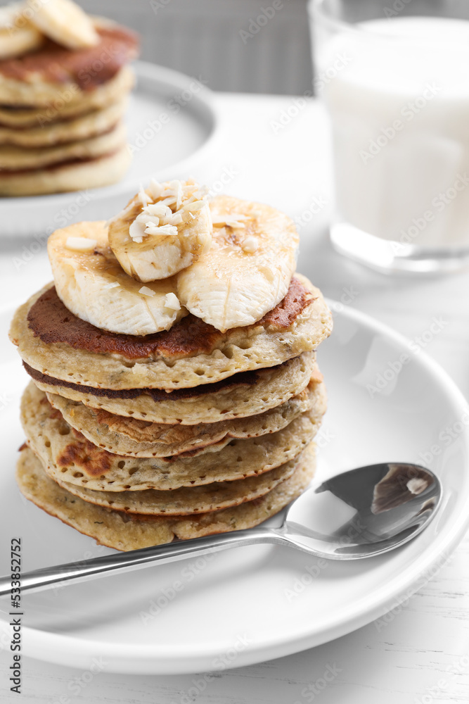 Plate of banana pancakes served on white wooden table, closeup Plate of banana pancakes served on white wooden table, closeup
