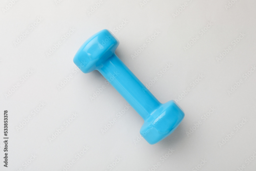 Blue vinyl dumbbell on light background, top view Blue vinyl dumbbell on light background, top view