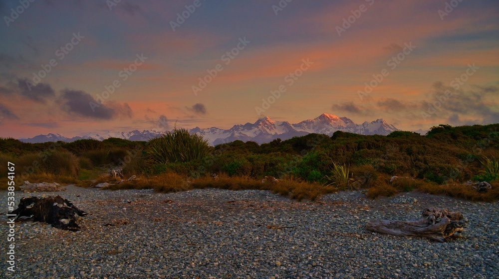 Aoraki/Mt. Cook, and Mt. Tasman at sunset from Gillespie's Beach, West Coast, New Zealand