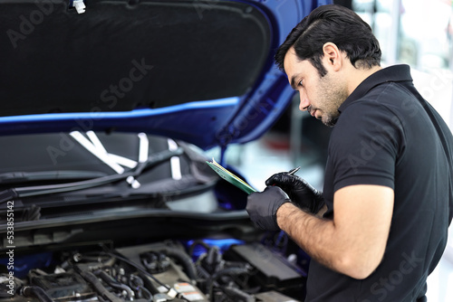 Car mechanic working with a Service checking car engine