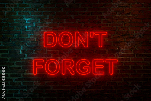Don't forget, neon sign. Brick wall at night with the text "Don't forget" in orange neon letters. Reminder, note and appointment concept. 3D illustration