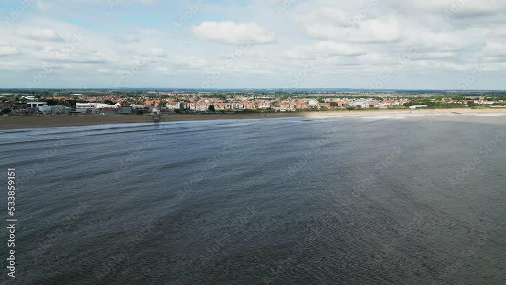 Typical English seaside resort, shot using a drone flying into the sun giving a aerial viewpoint with a wide expanse of beach with a pier and crashing waves.
Scene of people looking out from pier. Typical English seaside resort, shot using a drone flying into the sun giving a aerial viewpoint with a wide expanse of beach with a pier and crashing waves.
Scene of people looking out from pier.