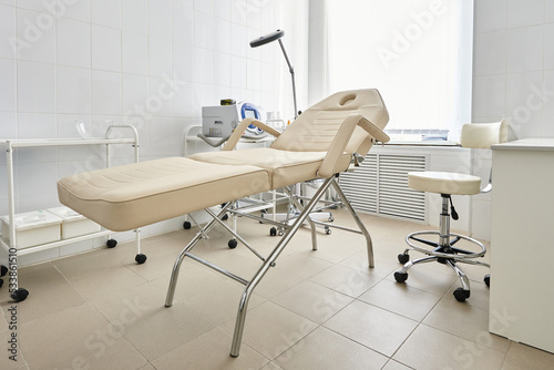 Treatment room with examination bed in beauty clinic