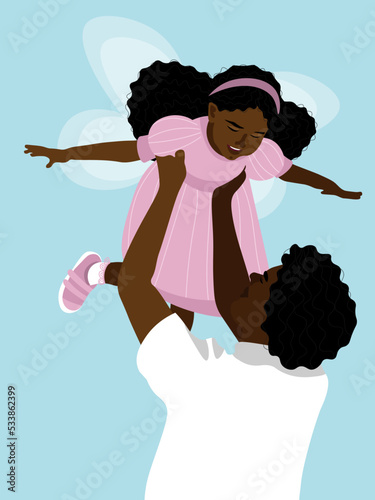 The father holds his daughter in his arms, who is dressed in a fairy costume.