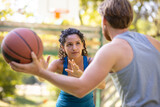 couple playing basketball together on the court
