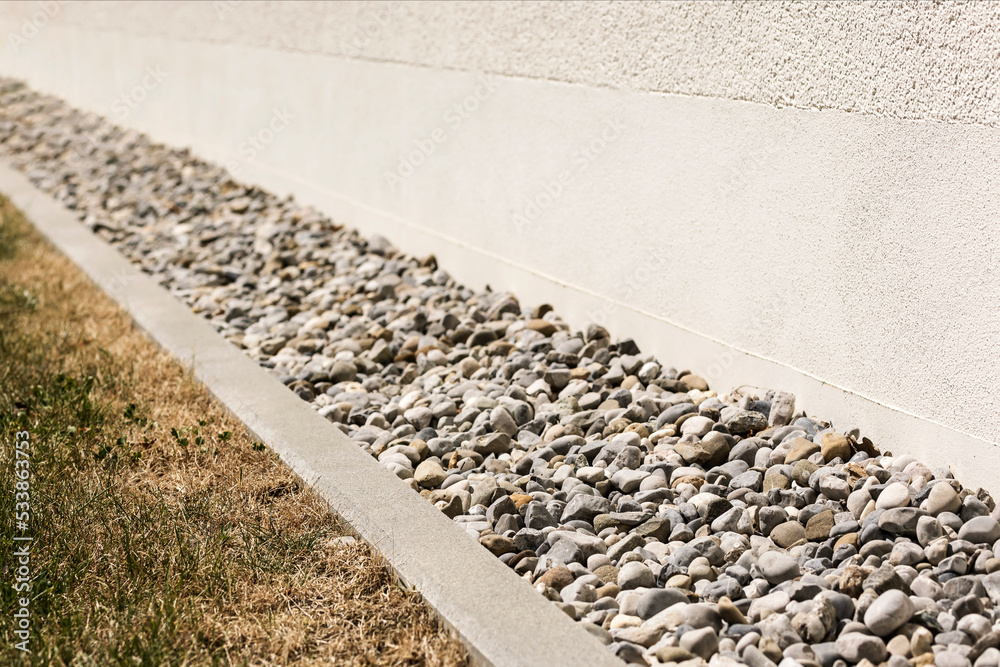 Drainage Gravel, Drain Stones, Pebble around Perimeter of House. Drain  Floor for Rain Storm water near Building Wall. Stock Photo | Adobe Stock