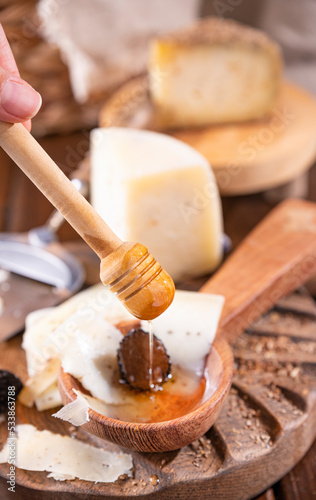 Pecorino cheese with truffle, traditional Italian sheep's milk cheese with truffle. A typical product of the dairy regions of Tuscany and Sardinia. Honey and cheese. High quality photo
