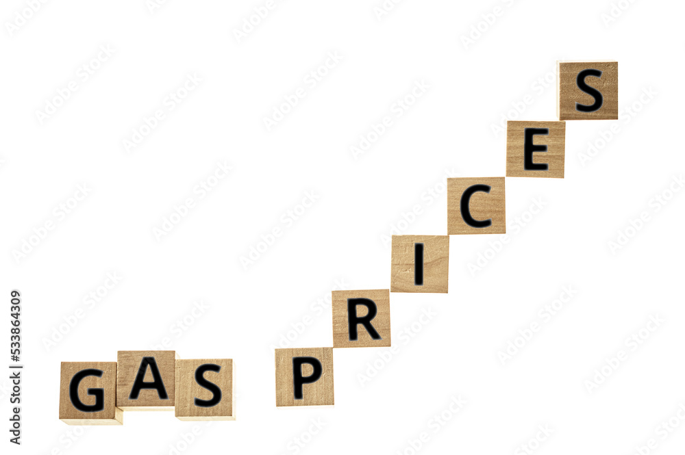Gas prices in black letters on wooden blocks on white background with space for copy Gas prices in black letters on wooden blocks on white background with space for copy