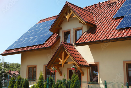 Exterior of beautiful house with solar panels on roof