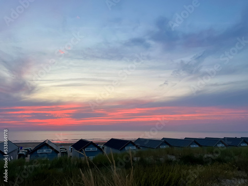 Many wooden houses on seacoast at sunset