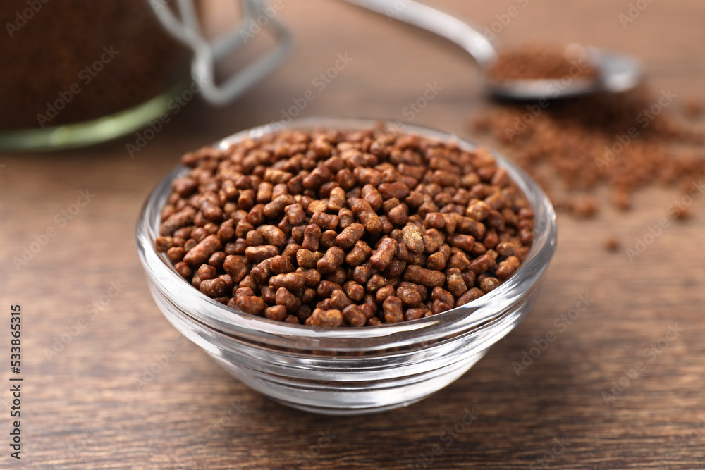 Buckwheat tea granules in glass bowl on wooden table, closeup Buckwheat tea granules in glass bowl on wooden table, closeup