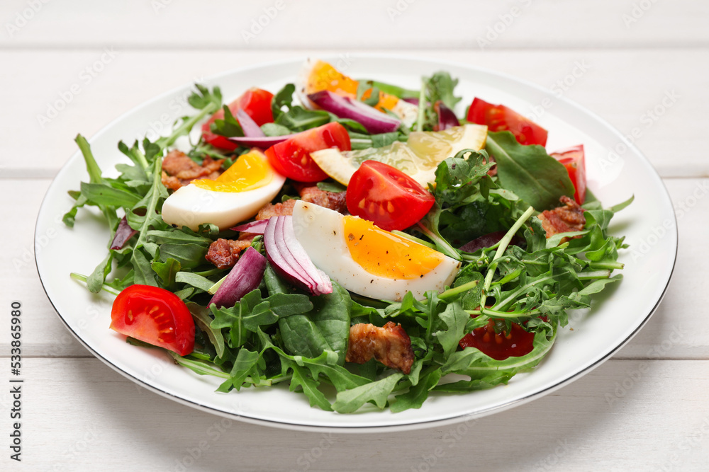 Delicious salad with boiled eggs, vegetables and bacon on white wooden table, closeup Delicious salad with boiled eggs, vegetables and bacon on white wooden table, closeup