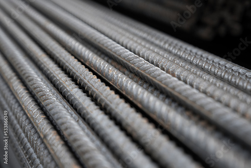 Reinforcing Steel Bar closeup. Reinforcement steel rod and deformed bar with rebar at construction site. Steel construction reinforcement with longitudinal ribs and transverse protrusions.