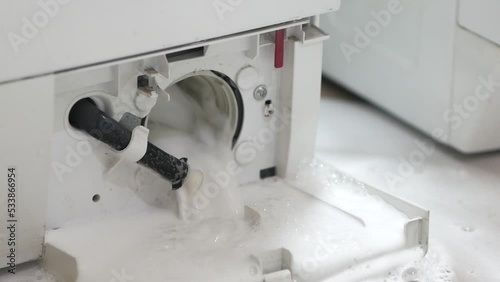 water flows out after extraction the pump filter in the washing machine