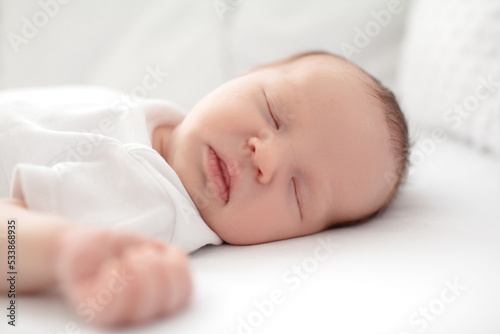 Home portrait of a sleeping newborn baby in a crib