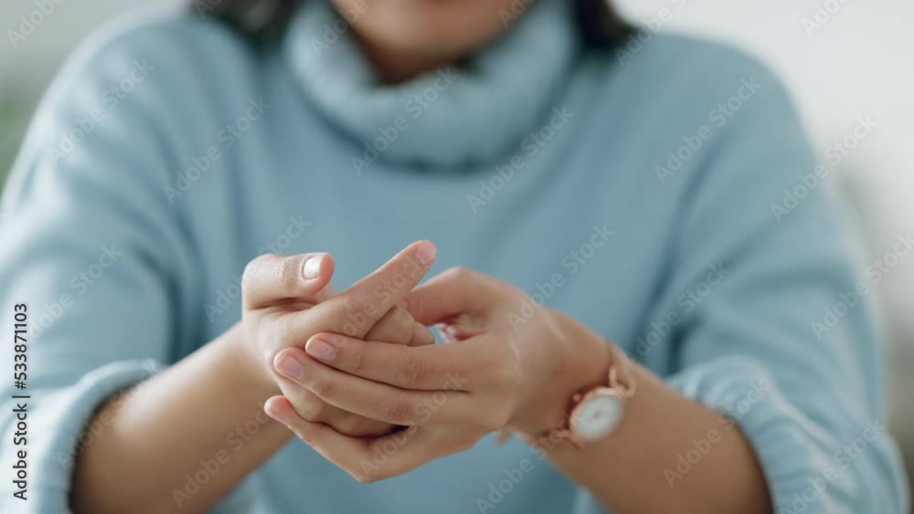 Woman cracking knuckles on her hands, anxiety and nervous gesture. Close up young female with stress, anxious and under pressure with habit to pop joints, knuckles and bones in finger and hand