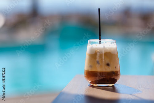 Photography Closeup view of an iced greek  coffee, also known as freddo cappuccino with a st
