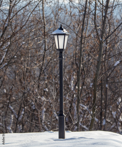 Lantern in the snow in the park