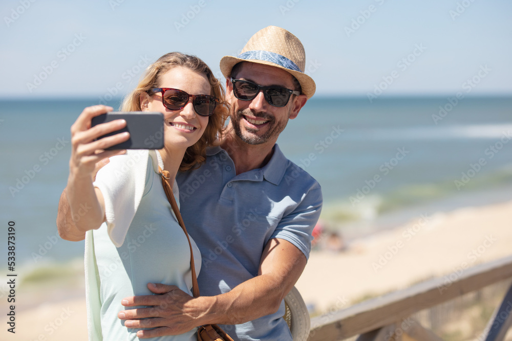 couple taking a selfie on the beach