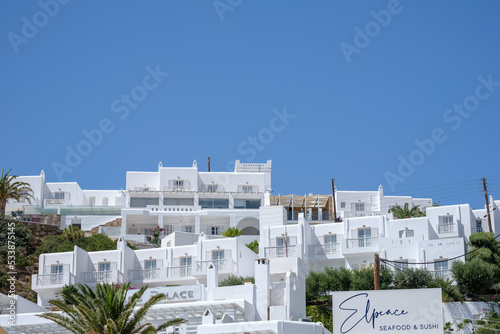 View of a luxury whitewashed hotel with balcony’s and the blue sky in Ios Greece