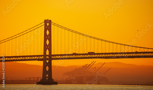Fototapeta Naklejka Na Ścianę i Meble -  San Francisco Oakland Bay Bridge landmark, beautiful sunrise with spectacular sky. Travel to California, United States.