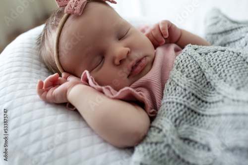 Home portrait of a sleeping newborn baby in a crib