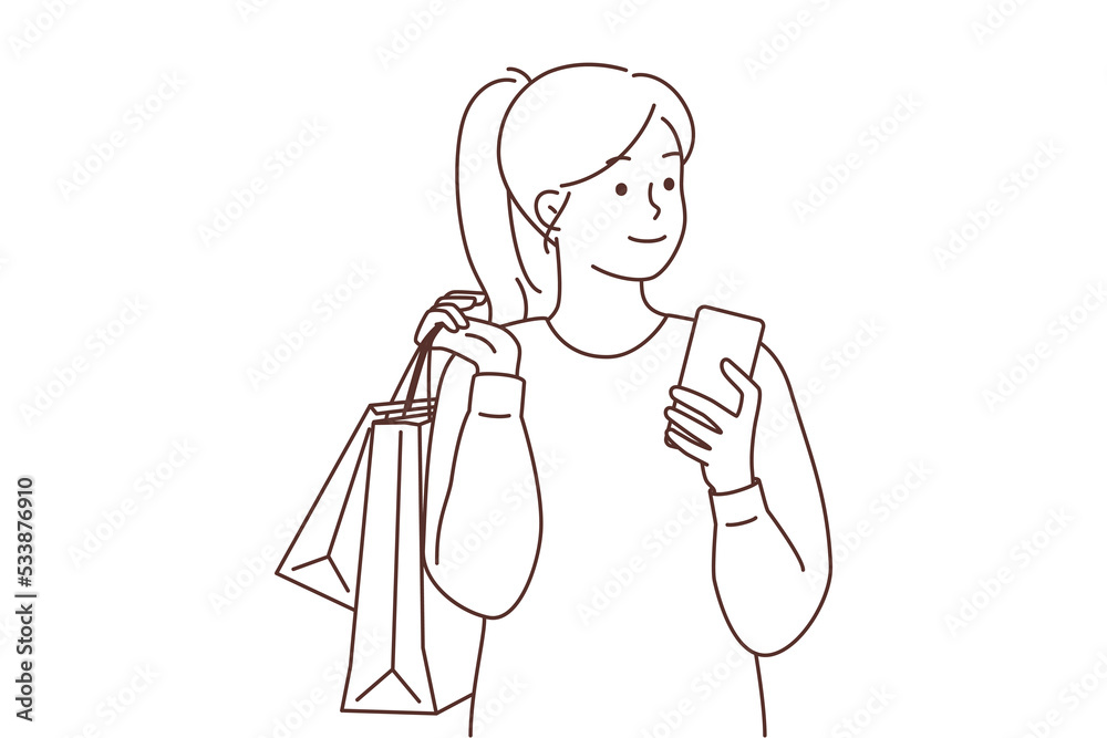 Happy woman with cellphone and shopping bags 