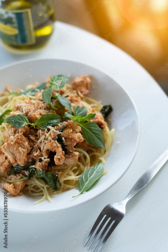 Italian cuisine: pasta with chicken and fresh basil