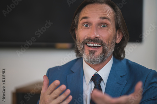 Bearded businessman in a suit looking surprised photo