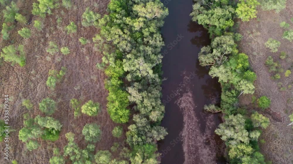 Certical drone view over the Victoria River at Kalkaringi at dusk, Northern Territory, Australia. 26 August 2022.