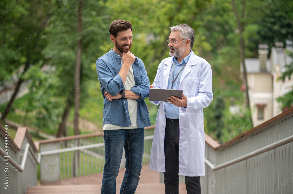 Male patient talking to the therapist regarding new emdicine Male patient talking to the therapist regarding new emdicine