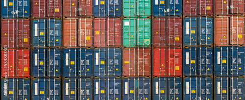 Stack of containers in a harbor. Shipping containers stacked on cargo ship. Background of Stack of Containers at a Port. photo