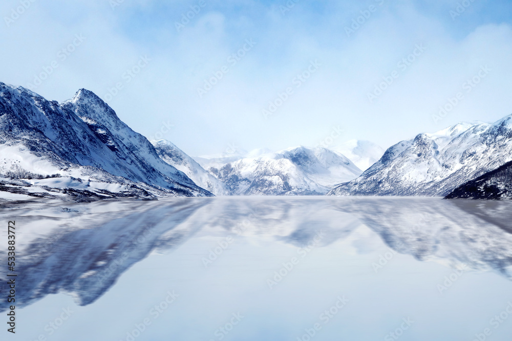 snow covered mountains with sea where sea make reflection of all view