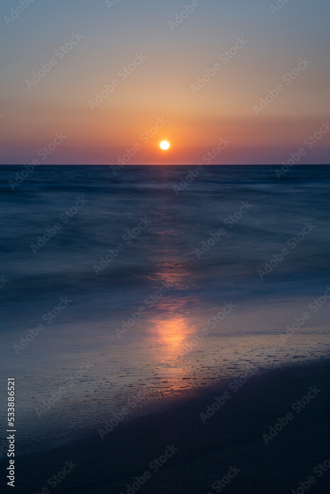 Long exposure by the sea. Waves break against stones. Sunset at the beach. Long exposure at night by the sea. Patara Beach Antalya Turkey Long exposure by the sea. Waves break against stones. Sunset at the beach. Long exposure at night by the sea. Patara Beach Antalya Turkey