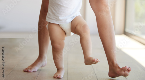 Obraz na plátne Baby, learning and walking with a child taking its first steps with his mother to learn to walk at home