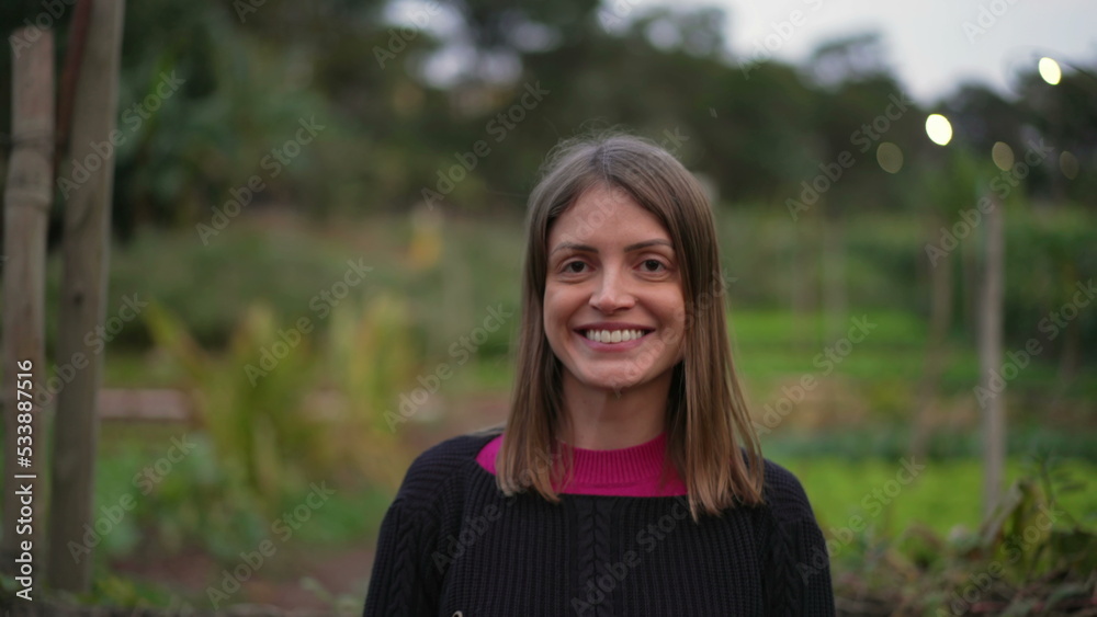 Portrait of a woman in 30s closeup face smiling at camera. Happy person in rural background Portrait of a woman in 30s closeup face smiling at camera. Happy person in rural background