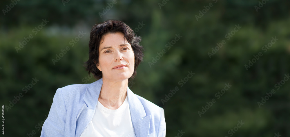 Summer lifestyle portrait smile middle aged woman looking at camera relaxes outdoor. Enjoying the little things. spends time in nature in summer. Summer lifestyle portrait smile middle aged woman looking at camera relaxes outdoor. Enjoying the little things. spends time in nature in summer.