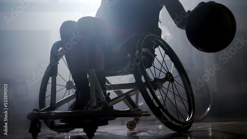 Tableau sur toile Disabled basketball player in wheelchair with dramatic lighting