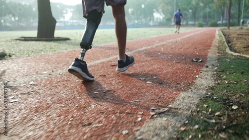 Bild auf Leinwand Determined disabled athlete running outside with prosthetic leg