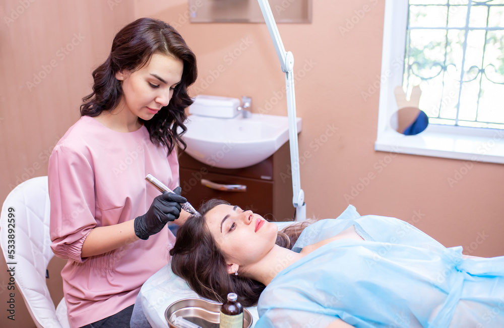 Treatment of the scalp for hair loss, alopecia. A trichologist doctor makes a dermapen procedure on the patient's head. Vitamin injections to improve hair growth. Treatment of the scalp for hair loss, alopecia. A trichologist doctor makes a dermapen procedure on the patient's head. Vitamin injections to improve hair growth.
