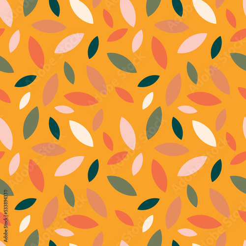 Autumn leaf fall on a yellow mustard background. Seamless cute pattern with leaves or grains in different colors. Vector.