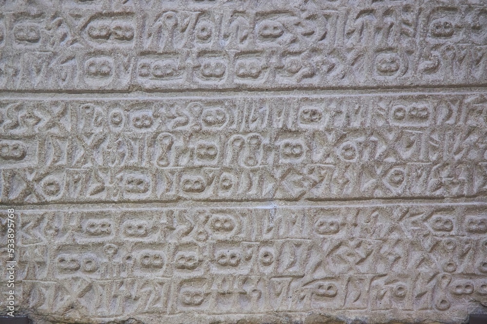 Ancient inscriptions on stone, close-up. Historical research and archaeology.
