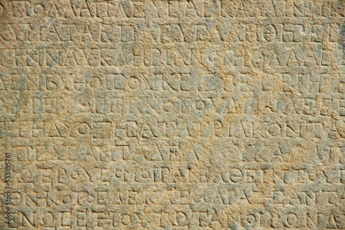 Ancient inscriptions on stone, close-up. Historical research and archaeology.