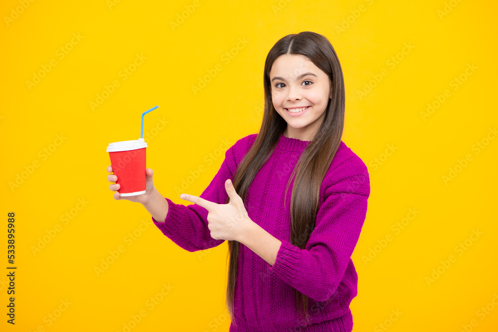 Teenager child with coffee cup isolated on yellow studio background. Girl drinking take away beverage. Teenager child with coffee cup isolated on yellow studio background. Girl drinking take away beverage.
